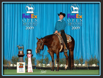 Eric Petersen is standing on a horse in front of a blue backdrop.