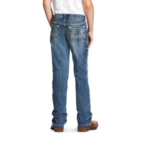 The boy is wearing Ariat Boys Jean Relaxed Boot Cut B4 Coltrane 10021160, standing with his back to the camera.