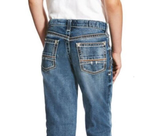 The back view of a boy wearing a pair of Ariat Boys Jean Relaxed Boot Cut B4 Coltrane 10021160.