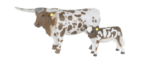 A Big Country Toy Ranch Set featuring a toy cow and calf on a white background.