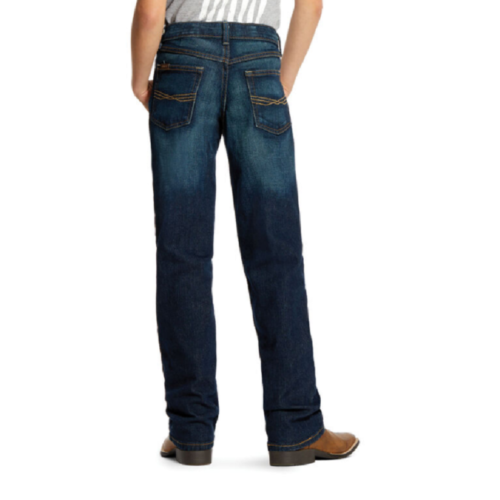 A boy wearing a pair of Boy's Ariat Jeans B5 Slim Fit Stretch 10023450.