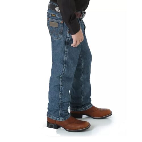 A boy wearing jeans and a Boy's Wrangler Cowboy Cut Original Fit 13MWJSW.