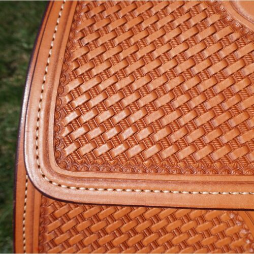 A close up of a 16 1/2" Custom Reiner Saddle tan woven saddle bag.