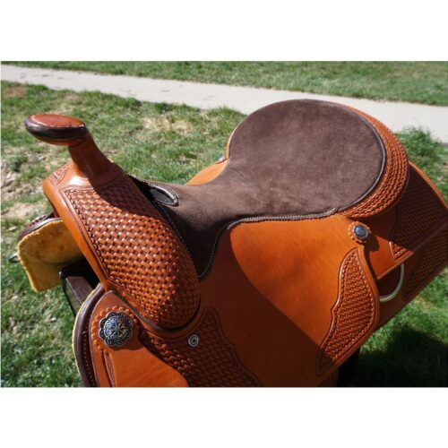 A brown 16" Custom Square Skirt Reining Saddle on a grassy area.