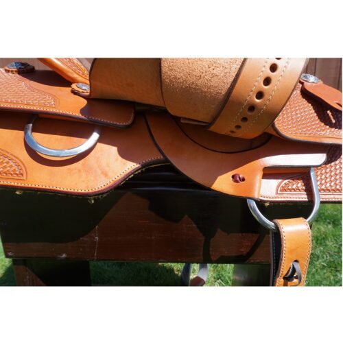 A 16" Custom Square Skirt Reining Saddle tan saddle on a wooden table.