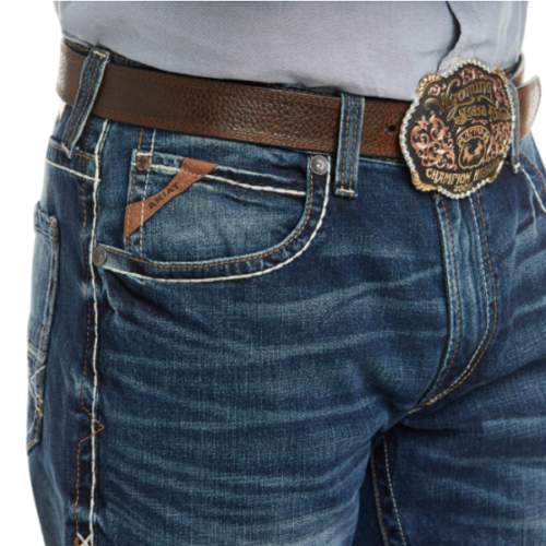 A man is wearing a pair of jeans with a buckle called Ariat Men's M4 Preston Low Rise Boot Cut Jean 10023455.