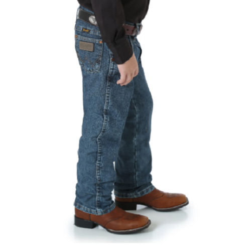 A boy wearing Boy's Wrangler Original Cowboy Cut Jean and a cowboy hat.