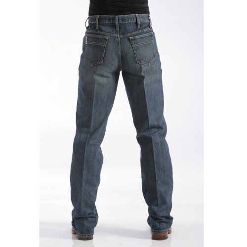 The back view of a man wearing a pair of Men's Cinch White Label Dark Stone Wash MB92834013 jeans.