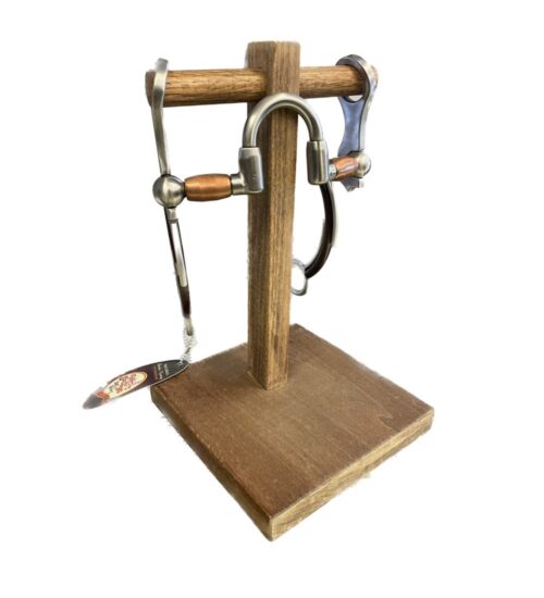 A wooden stand with a pair of horseshoes and the Tom Balding Pro Roller Bit on it.