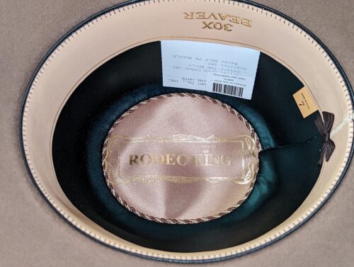 A Rodeo King 30X Tan Belly hat with a label on it.