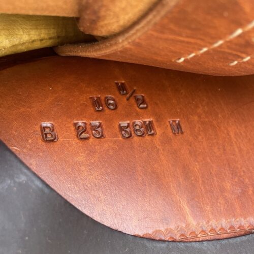 A close up of a Bob Avila 16.5" Reining Saddle with a number on it, featuring the keyword "leather shoe".