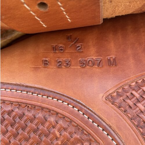 A close up of Bob's Lady Reiner 16" Saddle, a brown leather shoe with a number on it.