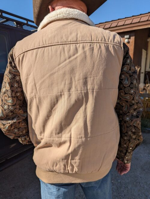 A man wearing a Men's Carry Conceal Canvas Vest.