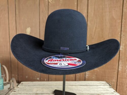 Black cowboy hat on display stand.