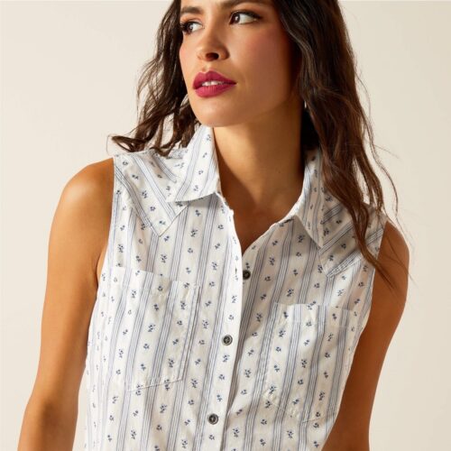 Woman wearing a white and blue floral shirt.